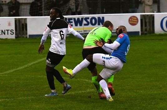 Faversham keeper George Bentley and Sheppey striker Warren Mfula collide. Picture: Marc Richards