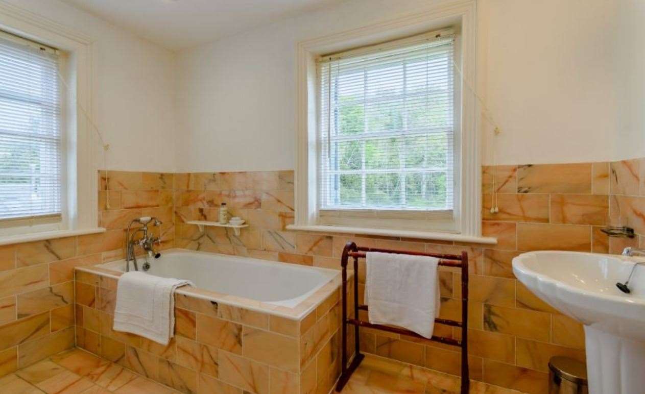 There are two en-suite bathrooms, along with a family bathroom and shower room. Picture: Strutt and Parker