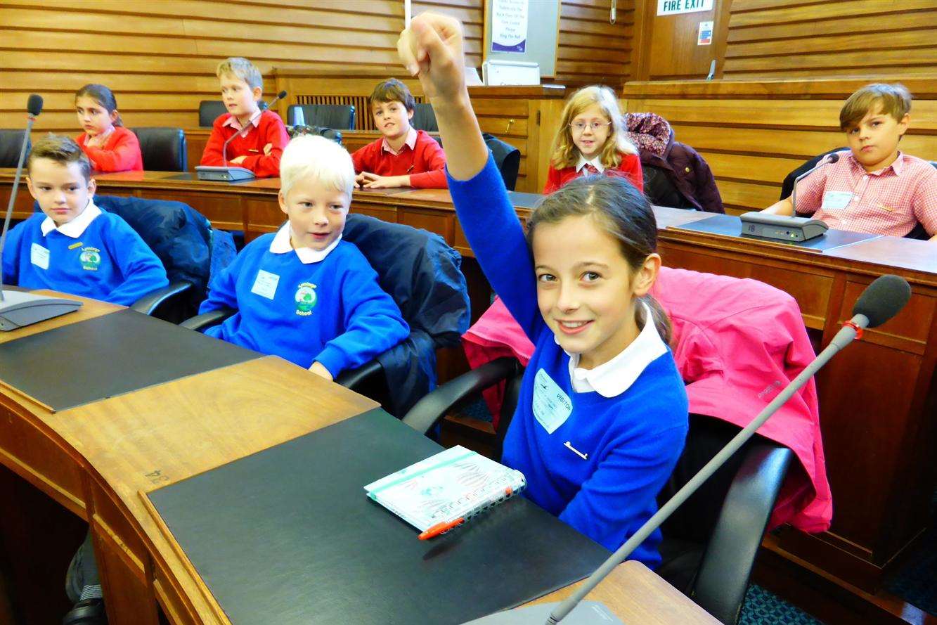 Anna Birkman, nine, of Lyminge Primary School, asks the Green Champion panel a question on air pollution, watched by William Smith, eight.