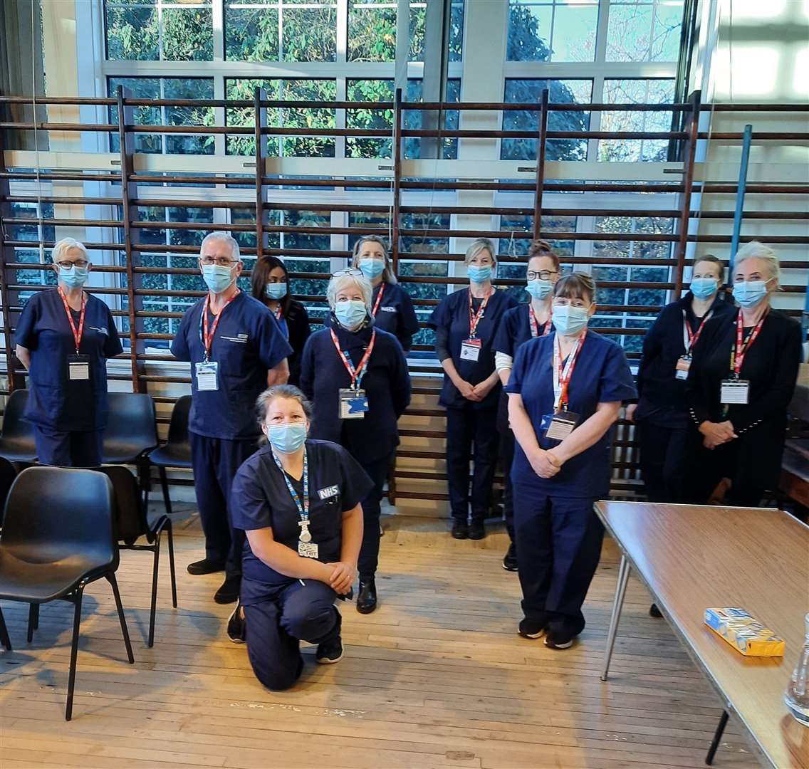 Jed and his colleagues waiting for students in the school gym