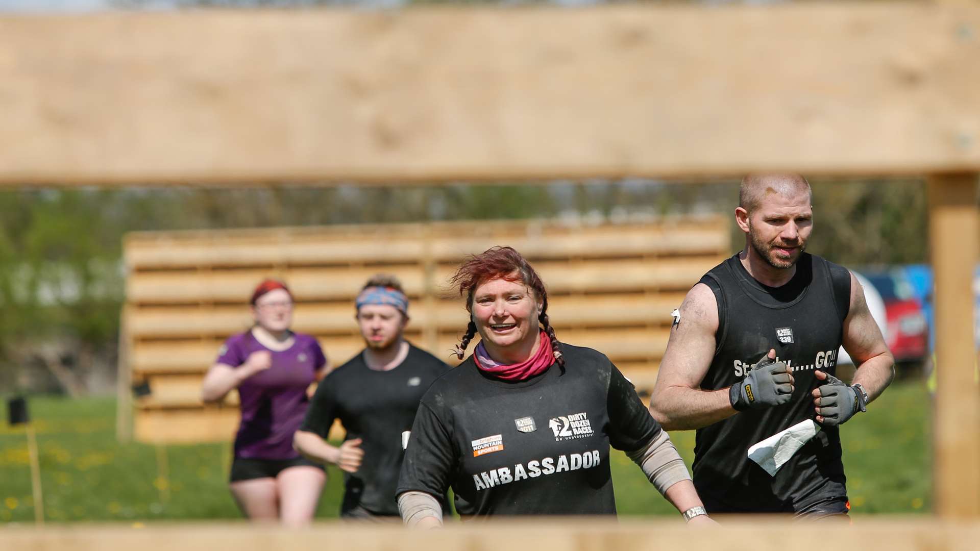 Helen Chapman gets ready to climb a fence at the Dirty Dozen Races. Picture by Matthew Walker.