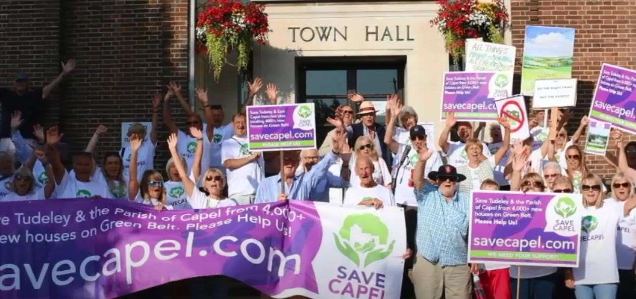 A protest agist the garden village outside the Town Hall