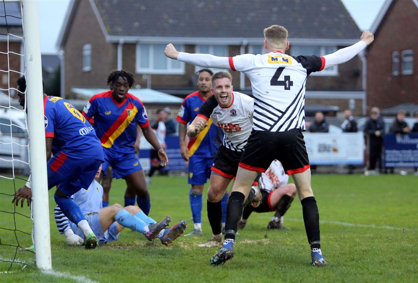 Aaron Millbank celebrates the first of his two goals with Alex Green against Holmesdale on Saturday Picture: Paul Willmott