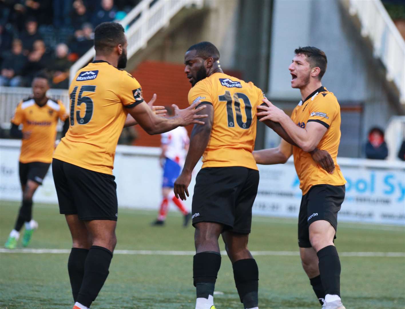 Goalscorer Ibby Akanbi is congratulated by Dan Wishart and Zihni Temelci Picture: John Westhrop