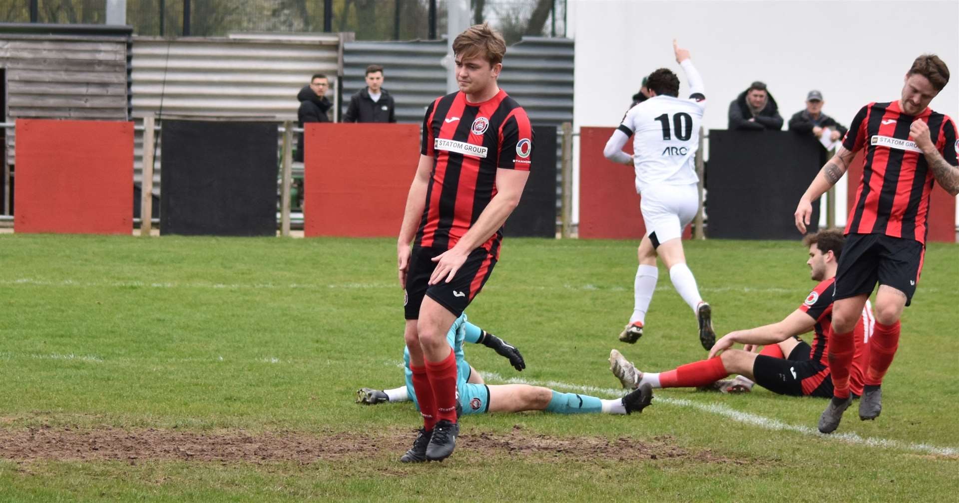 Billy Bennett (10) wheels away after opening the scoring for Faversham. Picture: Alan Coomes