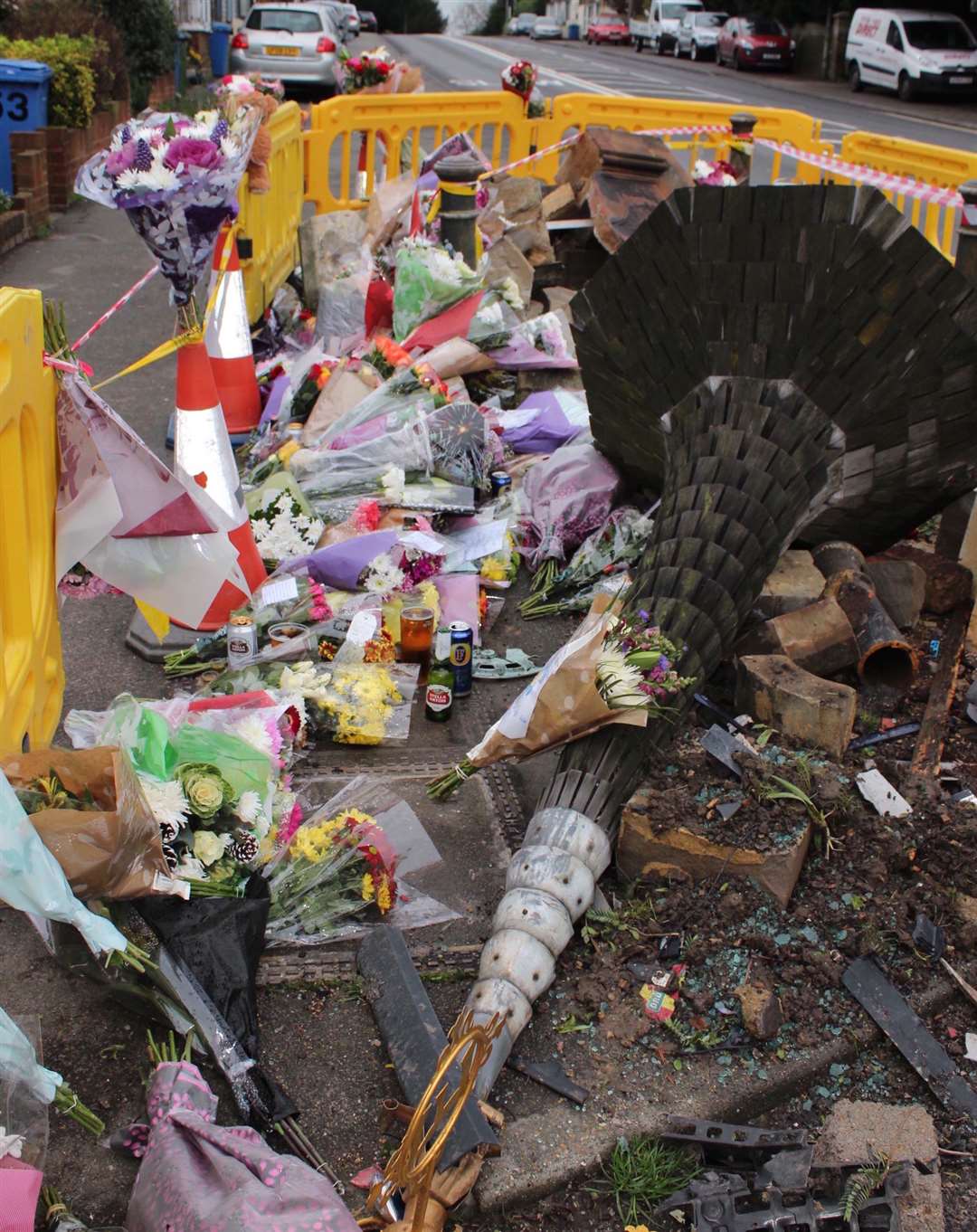 Tributes left to the two men who died after a crash in Teynham, which knocked down a village monument, in 2016