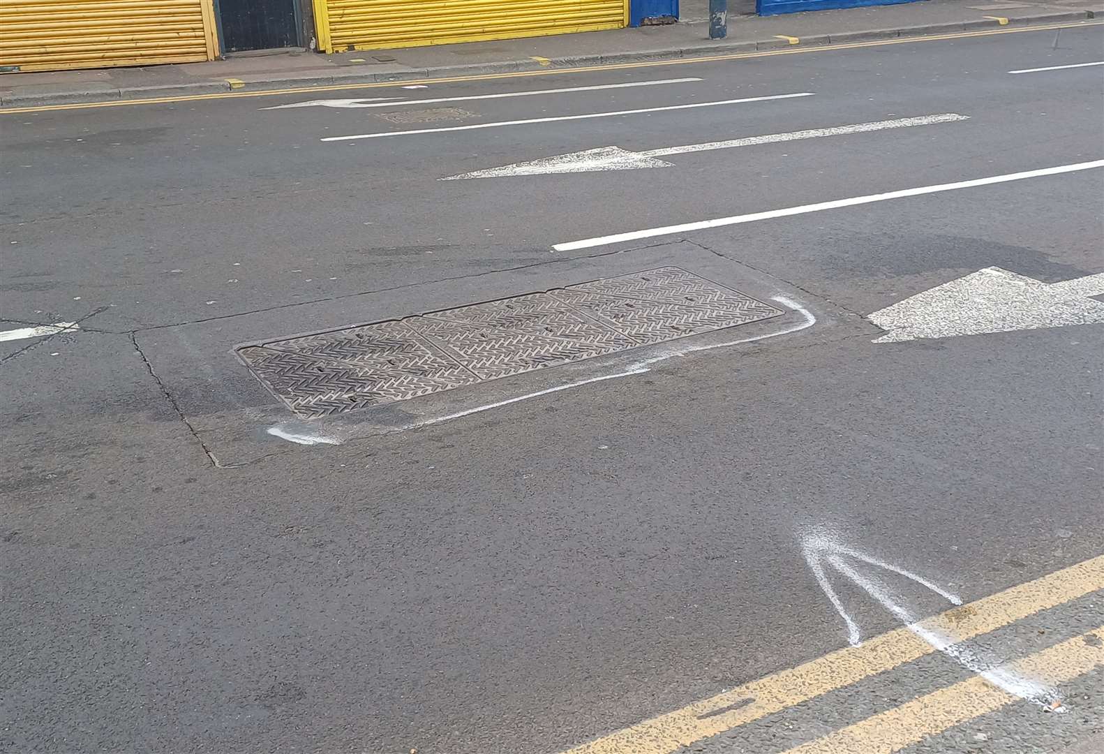 The loose manhole sounds like a "gun going off" when motorists drive over it