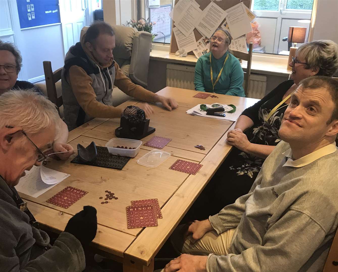 Service users play bingo inside as they adapt to a new routine