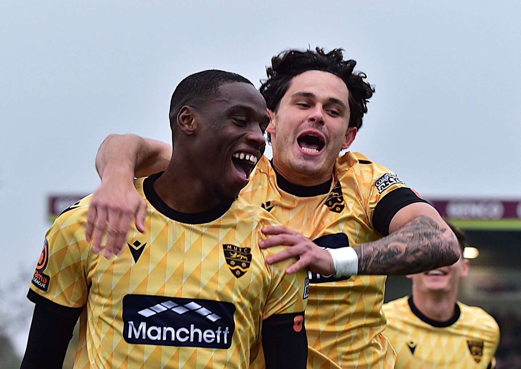 Temi Eweka celebrates his early goal at the Gallagher with Jon Benton. Picture: Steve Terrell