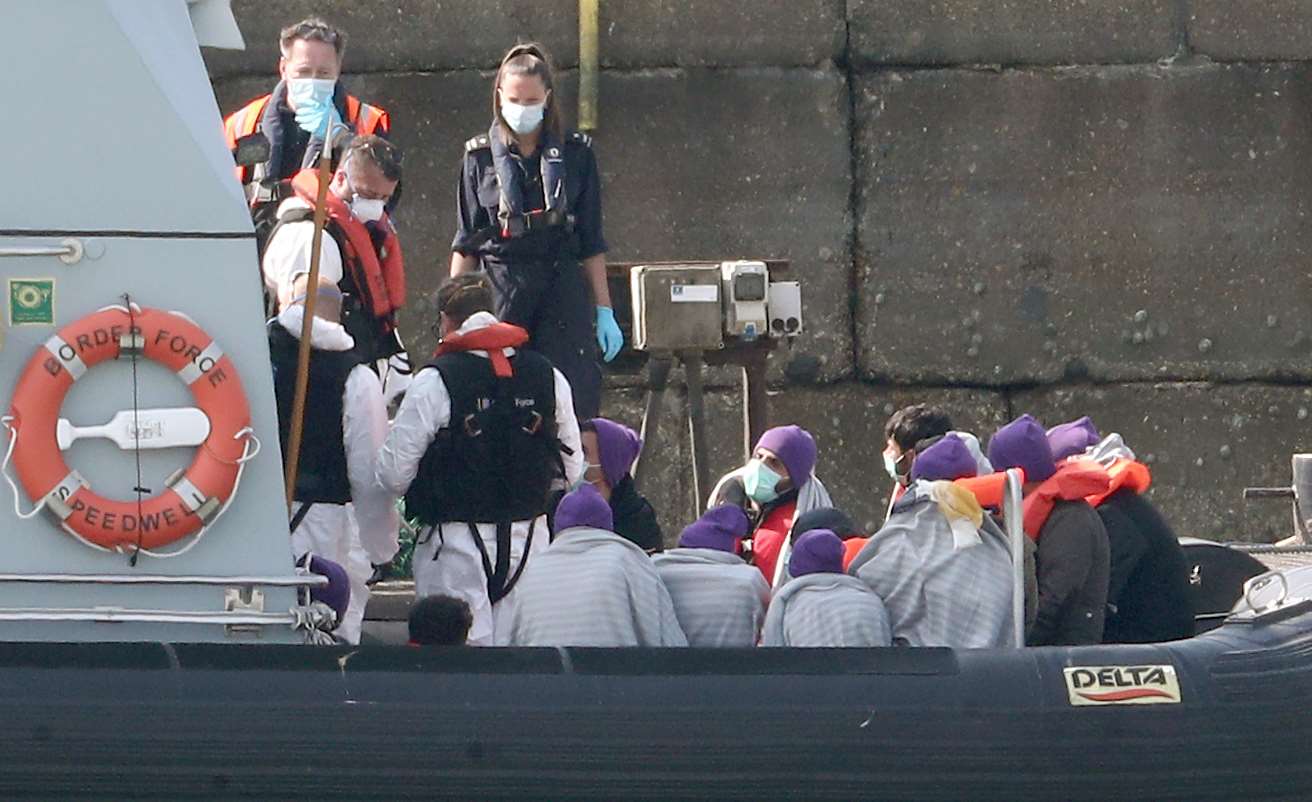 A group of people thought to be migrants are brought ashore on Friday (Gareth Fuller/PA)