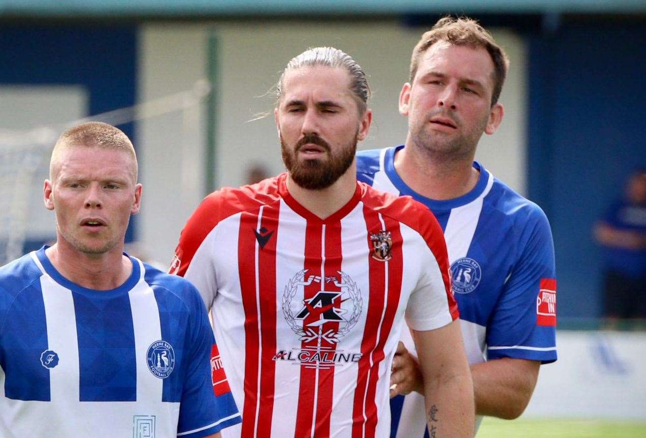 Herne Bay duo Scott Heard and Liam Friend sandwich Folkestone forward Tom Derry during Invicta’s 2-1 weekend defeat at Winch’s Field. Picture: James Aylward