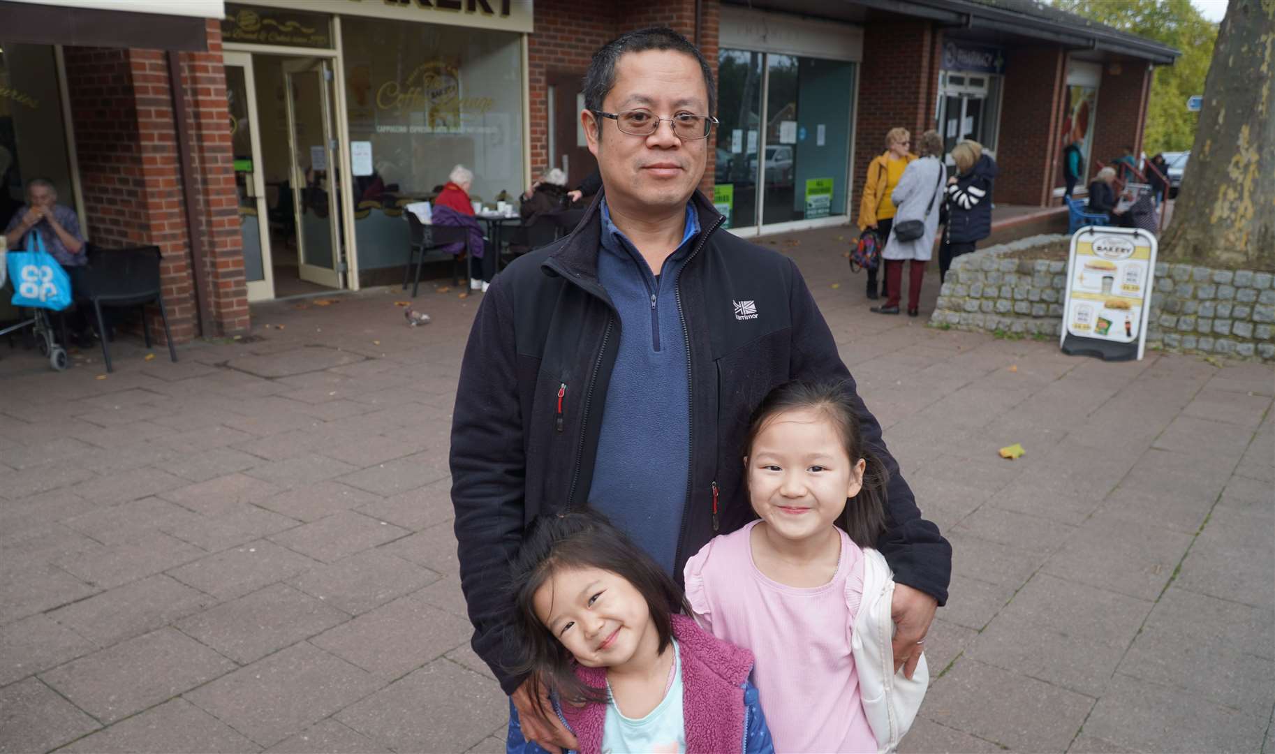 Sean Tong, who has been travelling further afield to cheaper swimming pools, with his two daughters