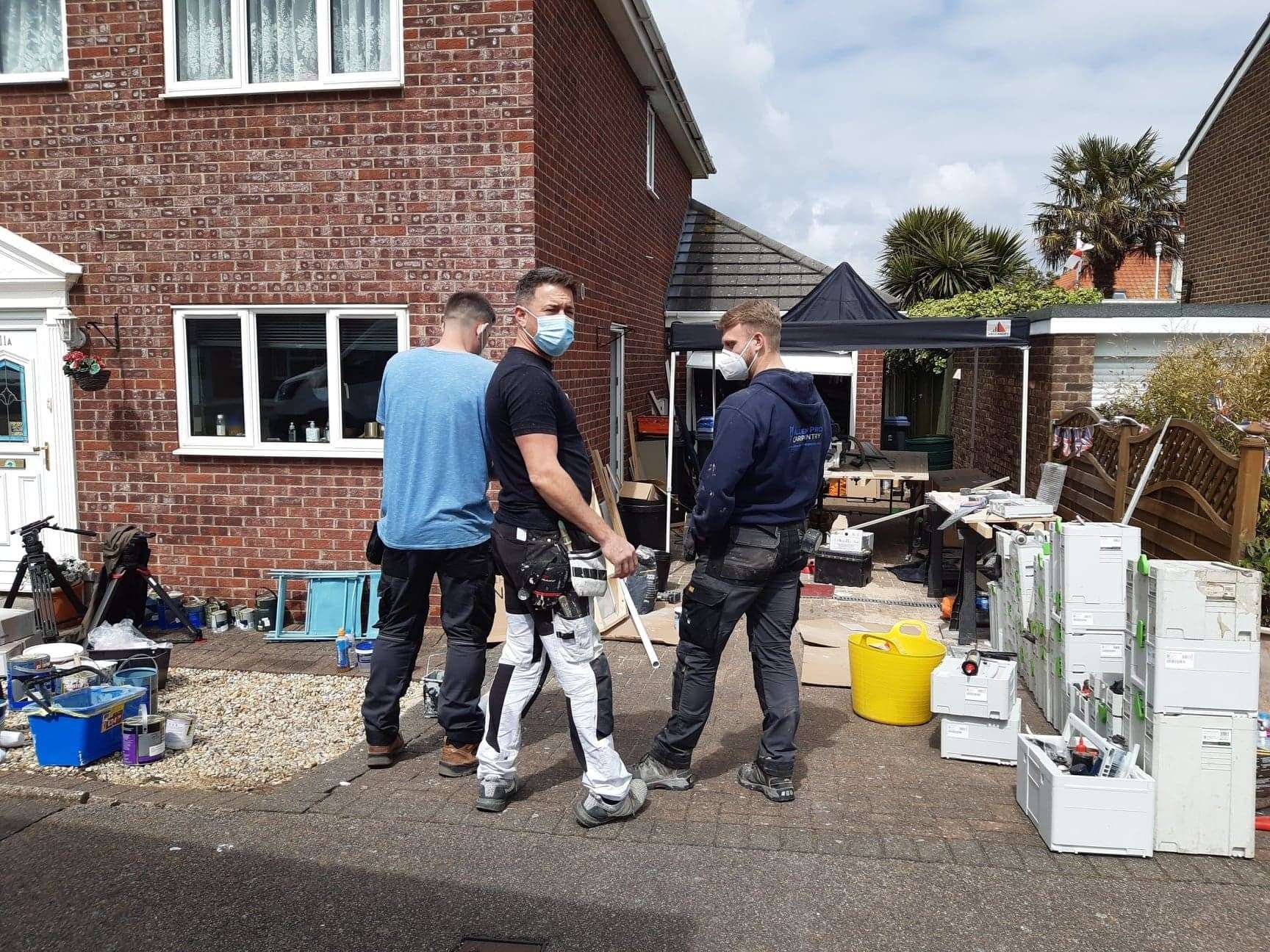 Tradesmen have a chat about how work is going inside