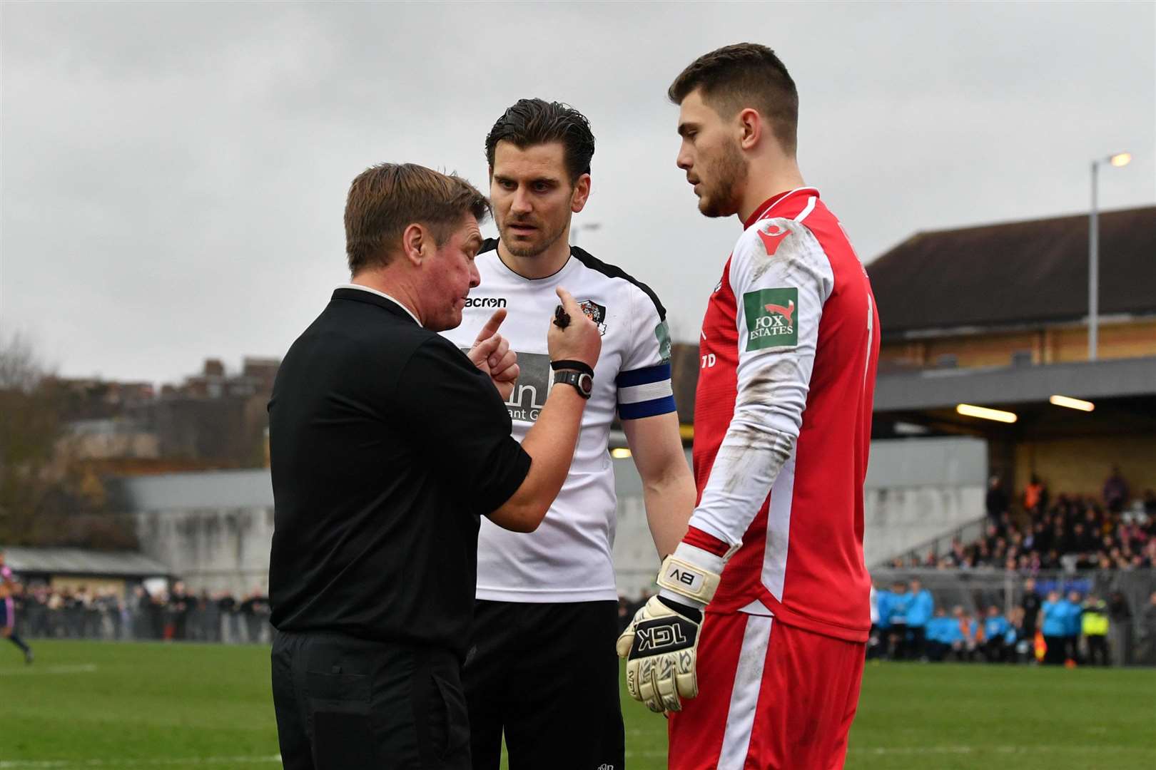 Referee David Spain talks to Tom Bonner and Bailey Vose Picture: Keith Gillard