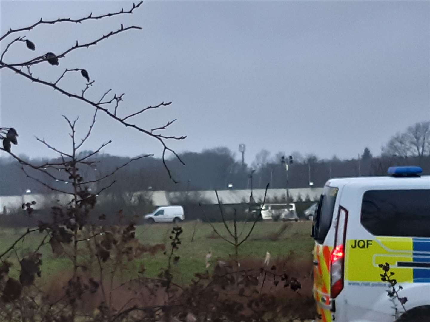 Officers lit floodlights this evening as they continue to search woodland in Ashford