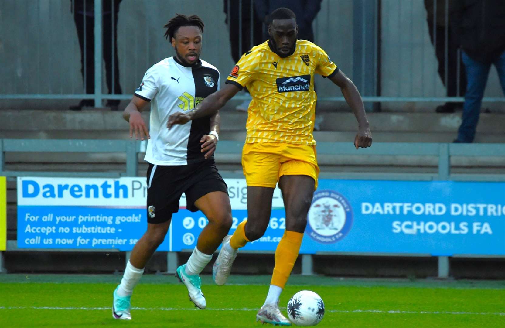 Maidstone striker Levi Amantchi gets away from Darts defender Joash Nembhard. Picture: Steve Terrell