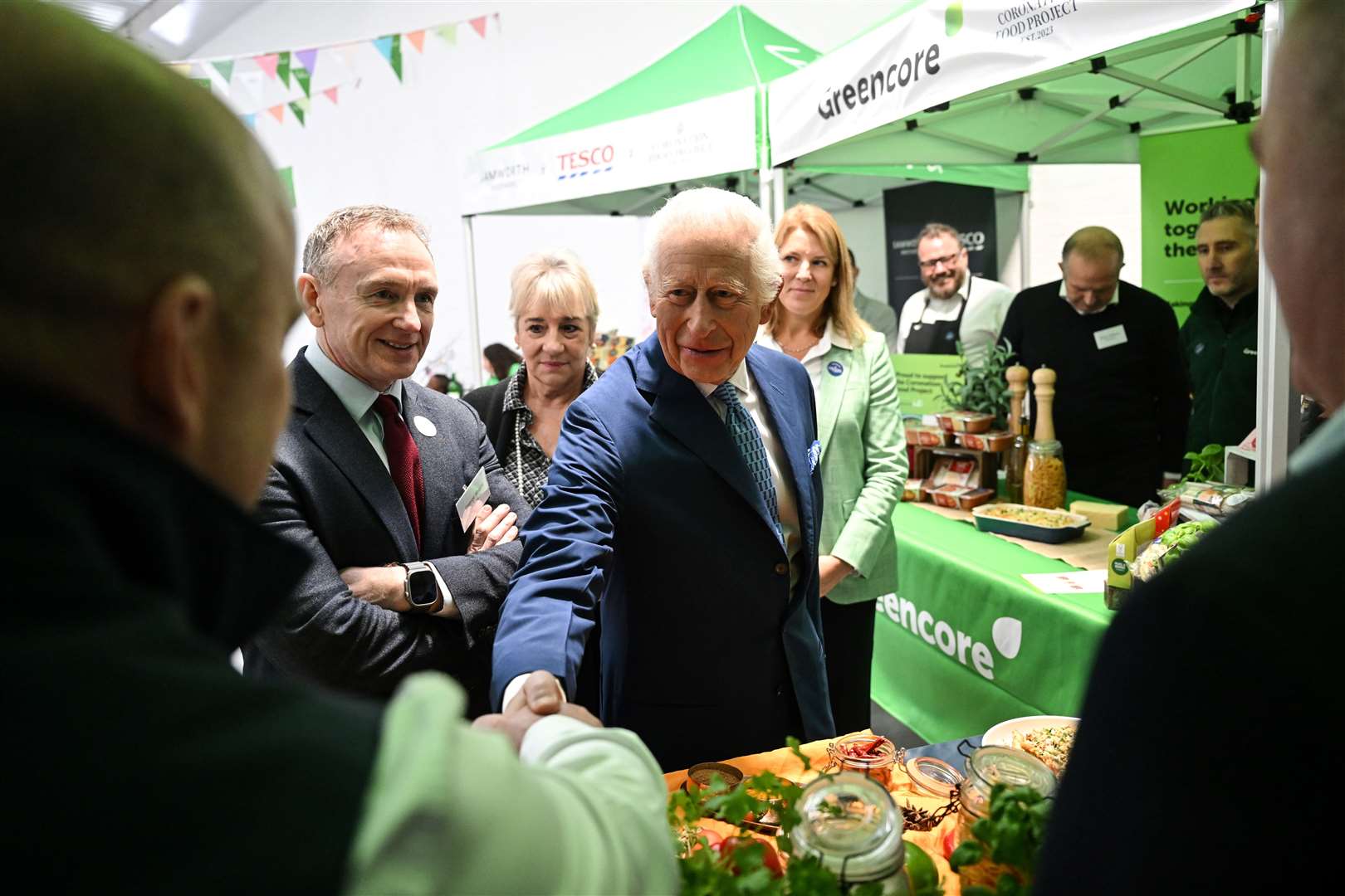 the King shakes hands with food suppliers at the Coronation Food Project hub in Deptford, south-east London (Justin Tallis/PA)