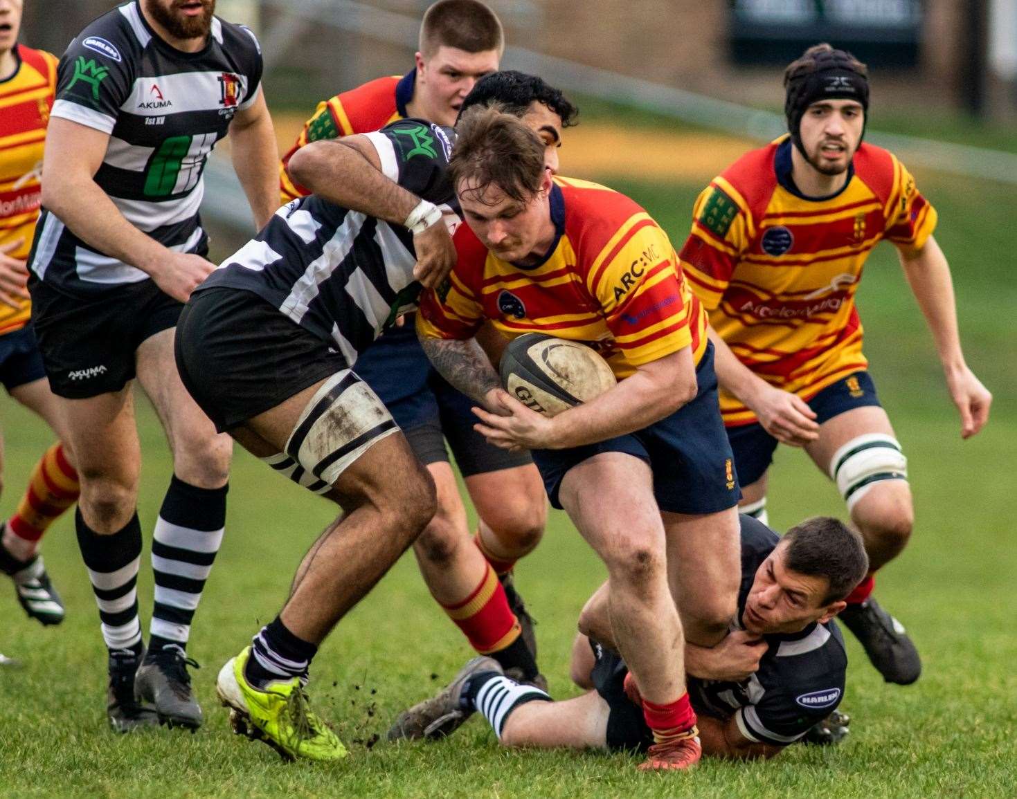 Ryan Eastleigh tries to escape Gravesend's clutches. Picture: Jake Miles Sports Photography