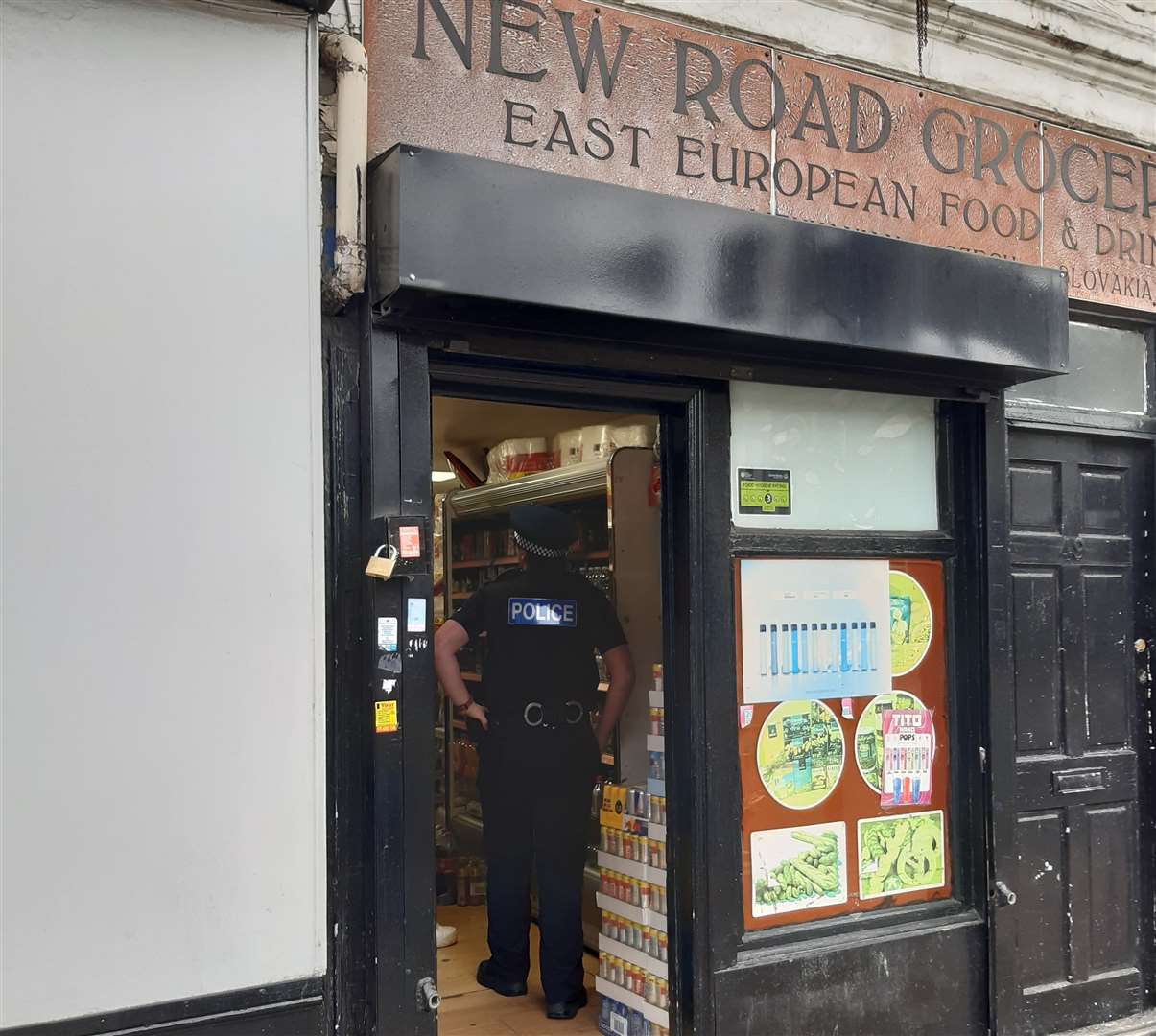 A police officer in New Road Groceries, in New Road, Gravesend, which was among the shops closed down