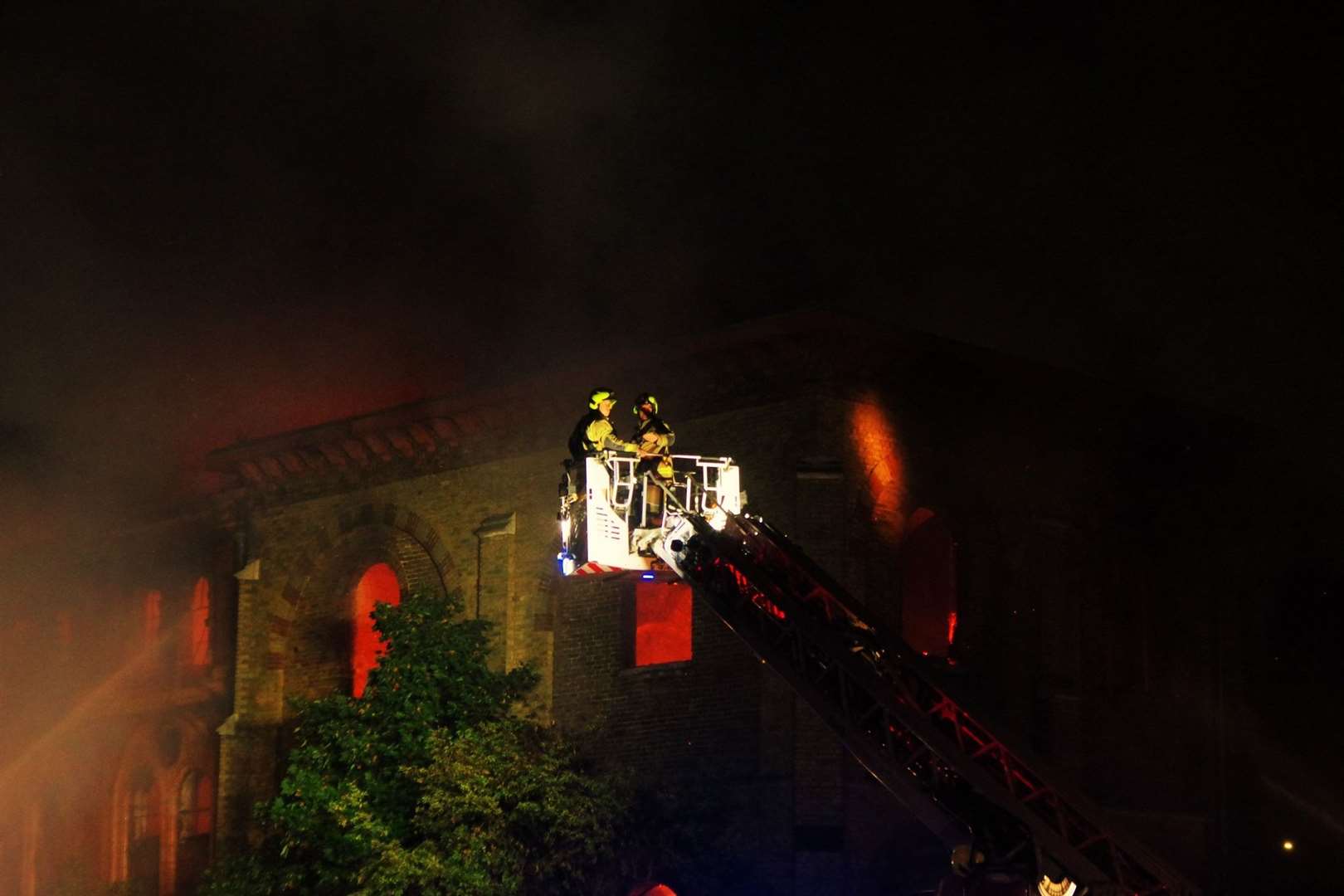 Firefighters using a crane to tackle the blazing water tower in Trinity Road, Sheerness. Picture: Phil Crowder