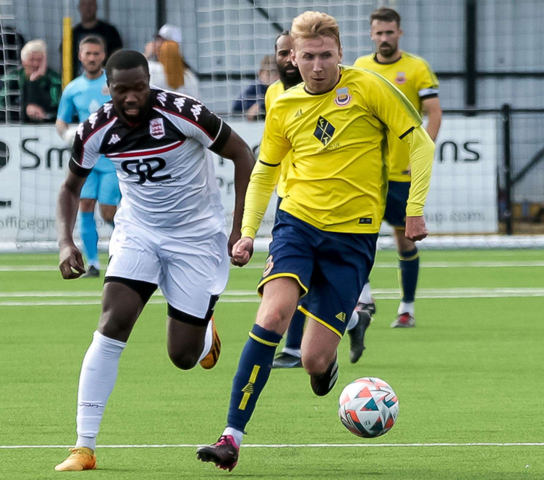 Faversham's Mo Kamara gives chase against Whitstable winger Harry Gamble on Monday. Picture: Les Biggs