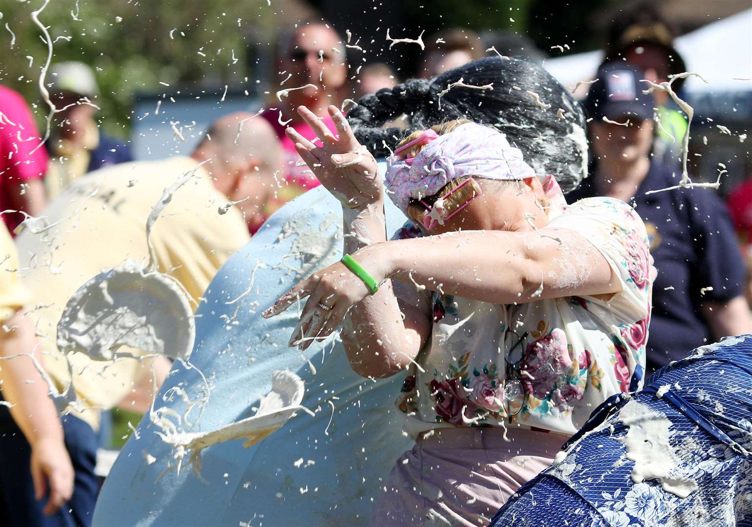 Crystal Schroder of the Granny Smith team from Essex takes cover during the annual World Custard Pie Championship in Coxheath, Kent (PA)