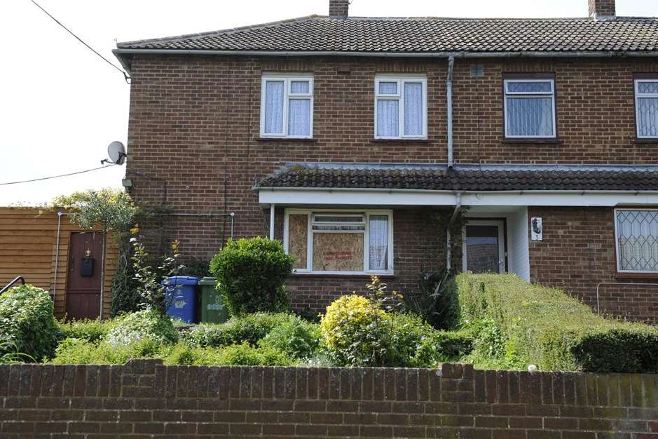 The window of the home in Larksfield Road is boarded up after Christopher Smith was taken away by police