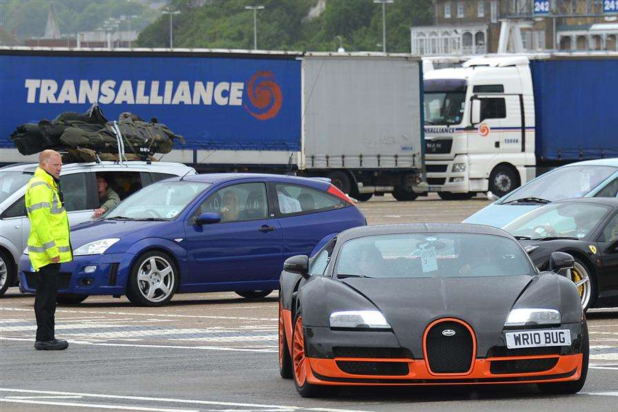 The world's fastest street legal car, the Bugatti Veyron Super Sport, gets an admiring glance from loading officer Sean Wanstall at Dover's Eastern Docks.