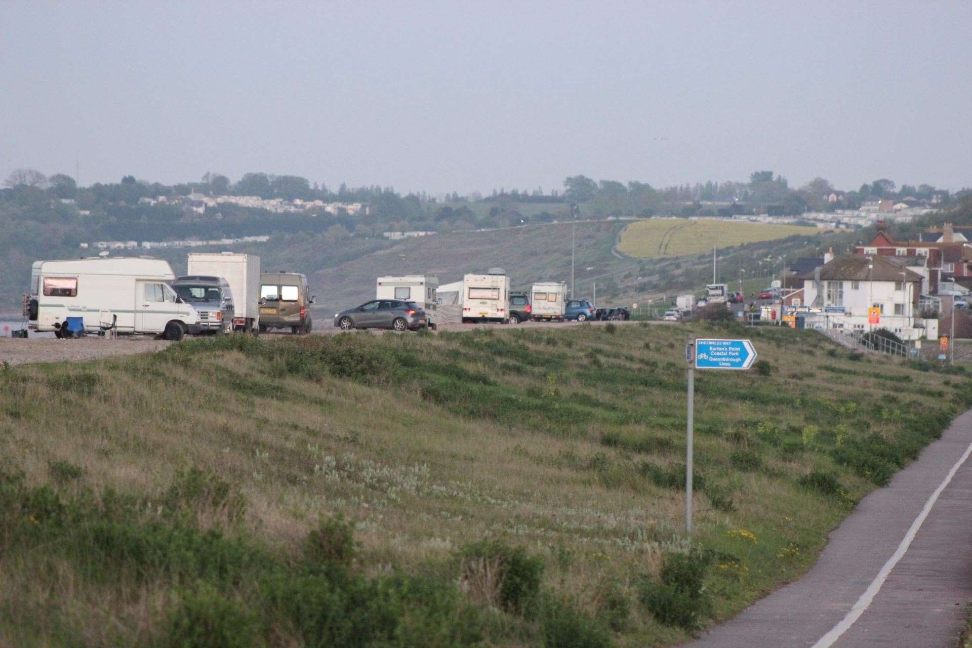 Camper vans and motorhomes on the shingle bank at Minster before the bollards