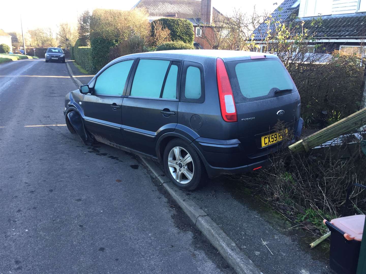 The second vehicle has knocked down a fence