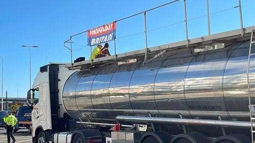 Insulate Britain on top of a tanker at the port. Photo: Kevin Clark