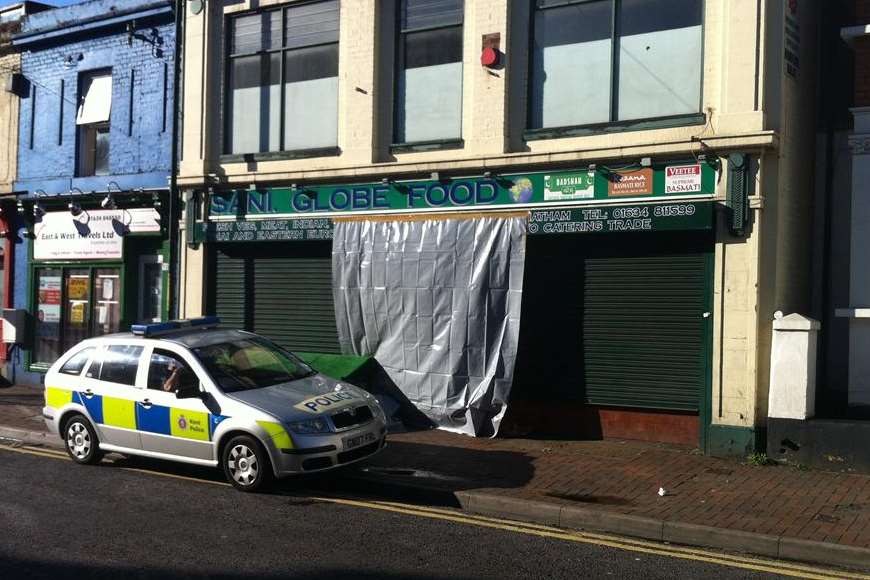 Police outside the Sani Globe food store, where Mrs Chaggar's body was discovered