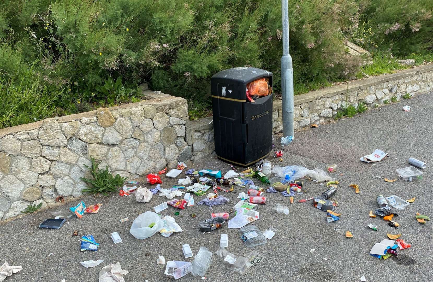 Food packets surround a bin after a sunny weekend in Folkestone. Picture: Stephen West