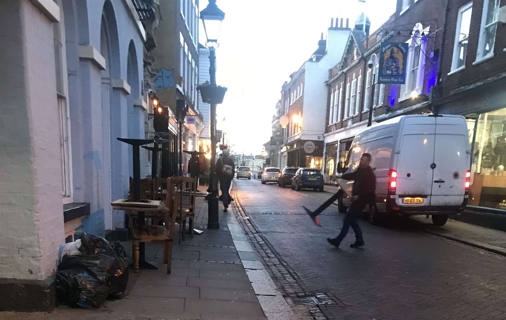 Furniture stacked on the pavement outside Mexicano