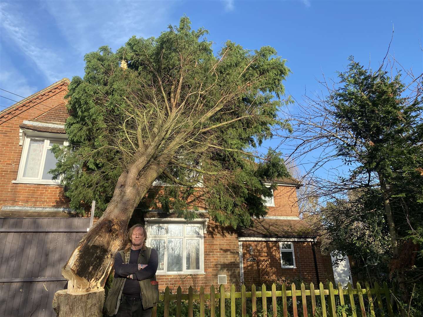 Mike Stygal outside his home with the fallen tree