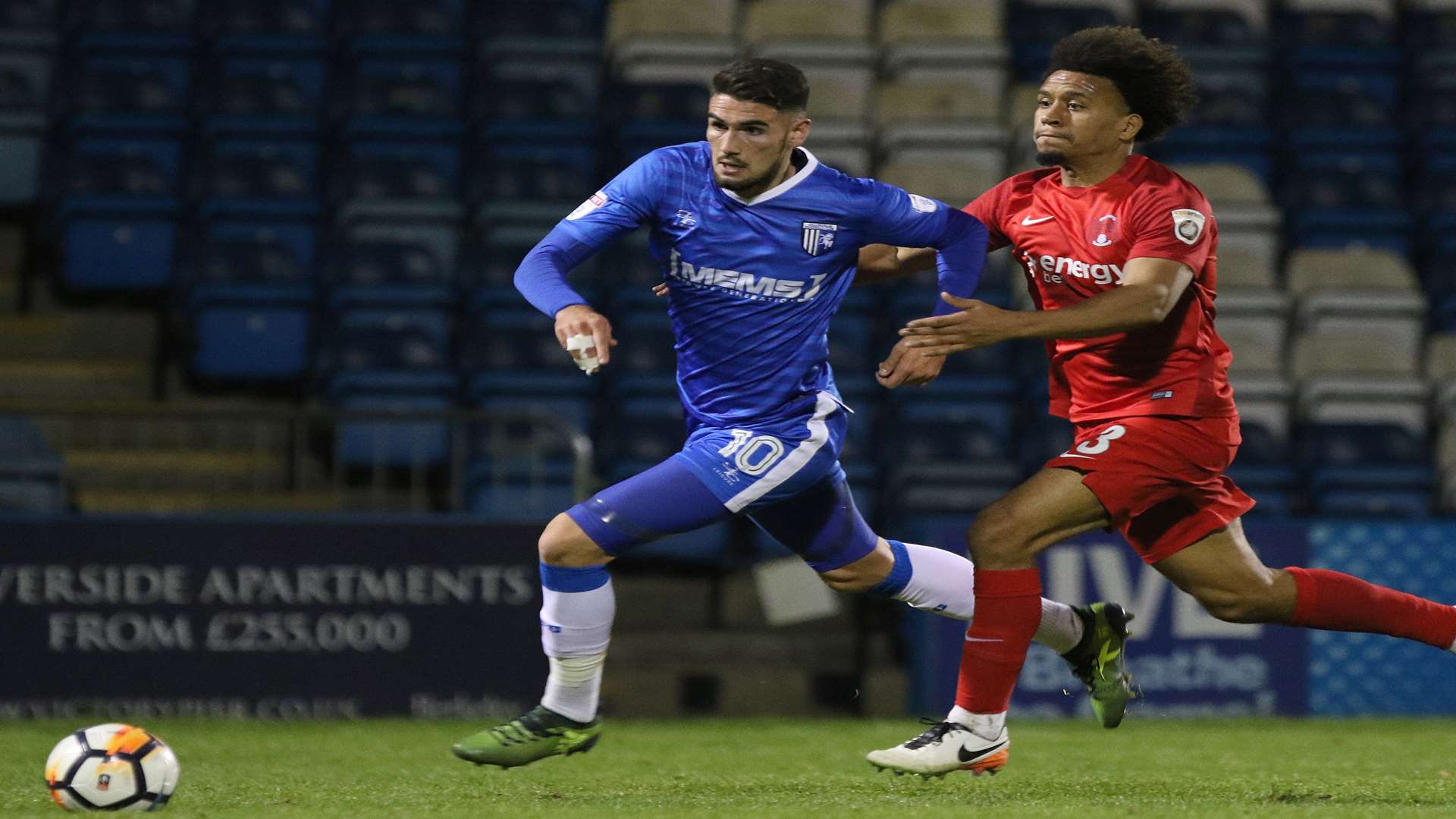 Conor Wilkinson is held back by Orient defender Joe Widdowson, who received his second yellow card for the foul Picture: Andy Jones