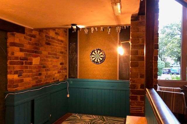 Even the dartboard wasn't safe - if you look carefully you'll see plastic flowers hanging above it