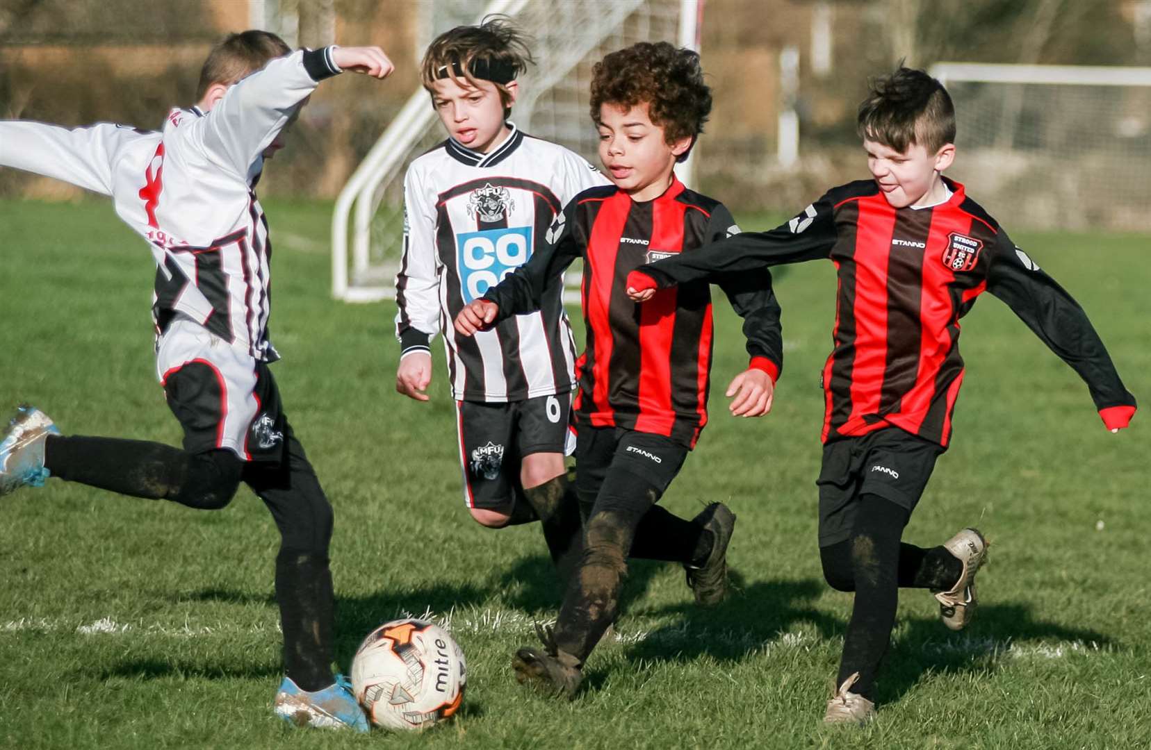 Milton and Fulston Zebras under-7s (Black/White) are closed down by Strood United under-7s. Picture: Phil Lee FM27123847