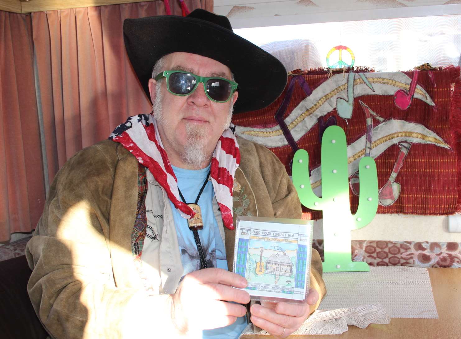 Rob Ellen in his mobile camper van "studio" with copies of his CDs