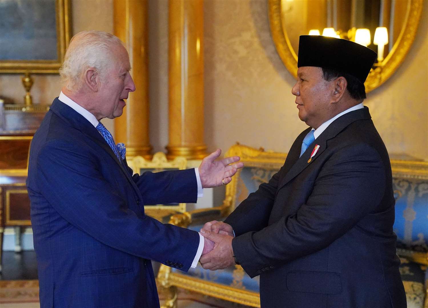 Charles shakes hands with the president (Jonathan Brady/PA)