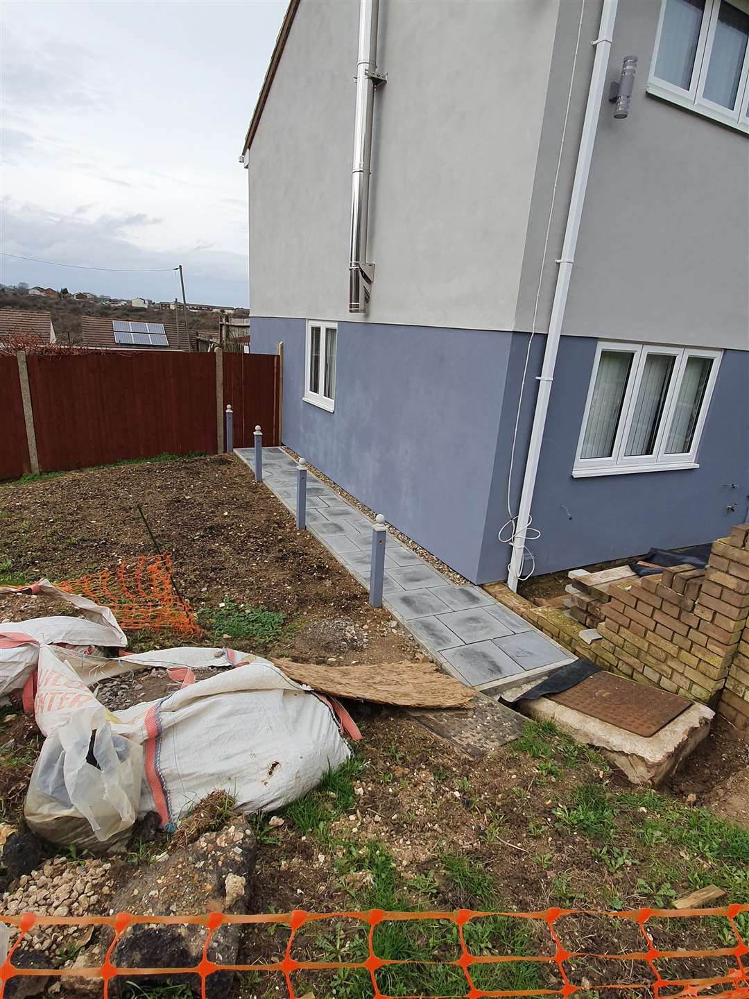 Paved pathway alongside the house