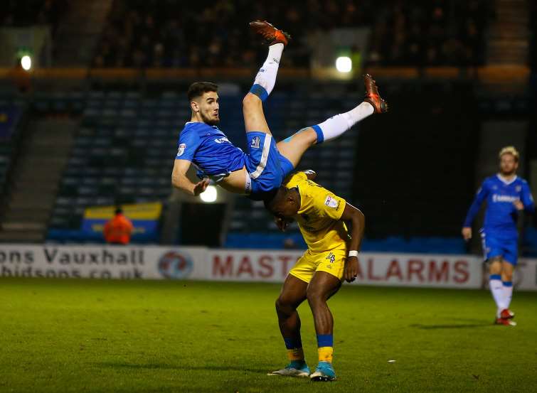 Gillingham striker Conor Wilkinson takes a tumble Picture: Andy Jones