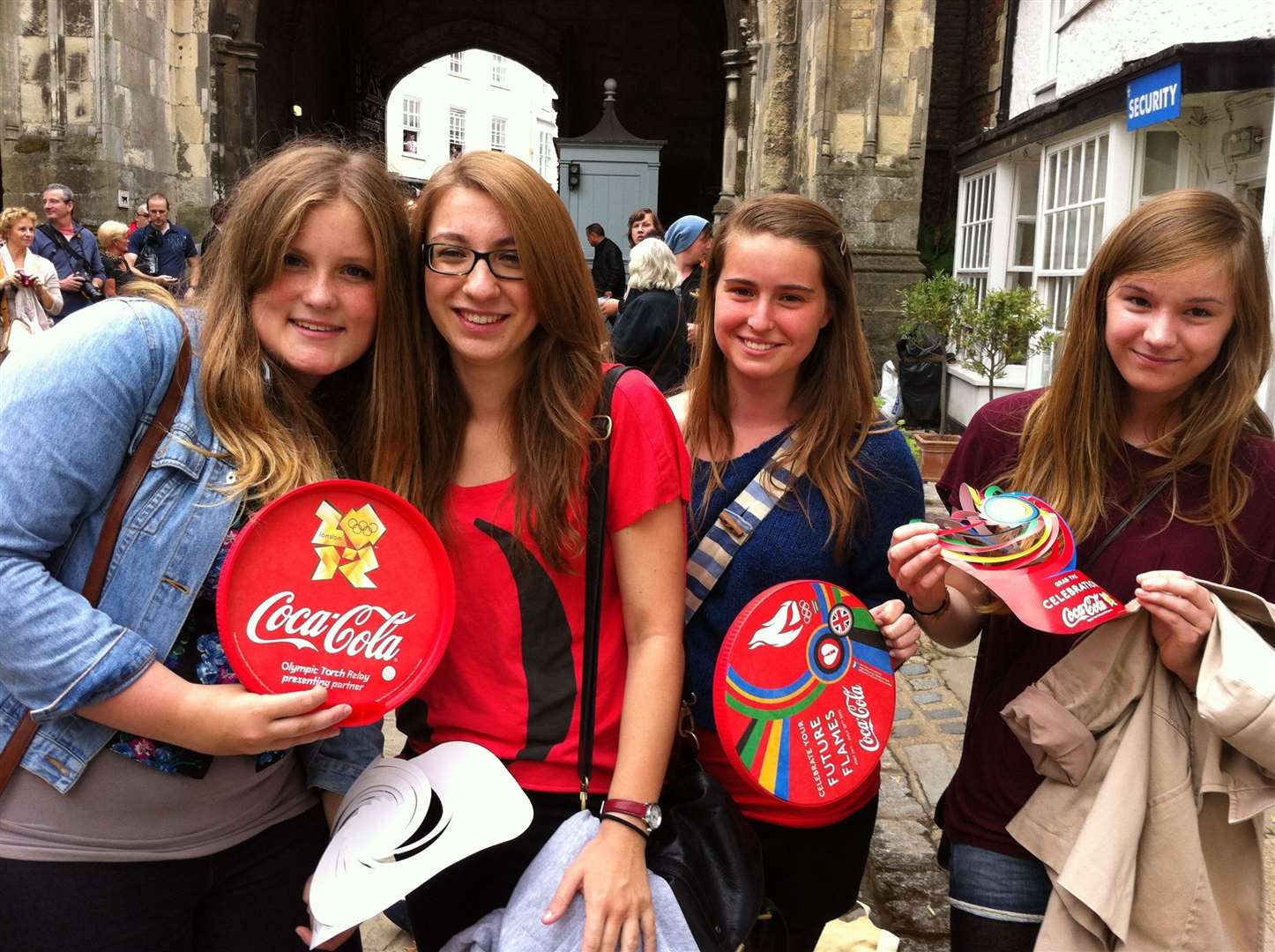 Hannah Tonry, Sophie Clark, Alice Golton and Eleanor Perkins, all 16, wait for the Olympic torch outside Canterbury Cathedral