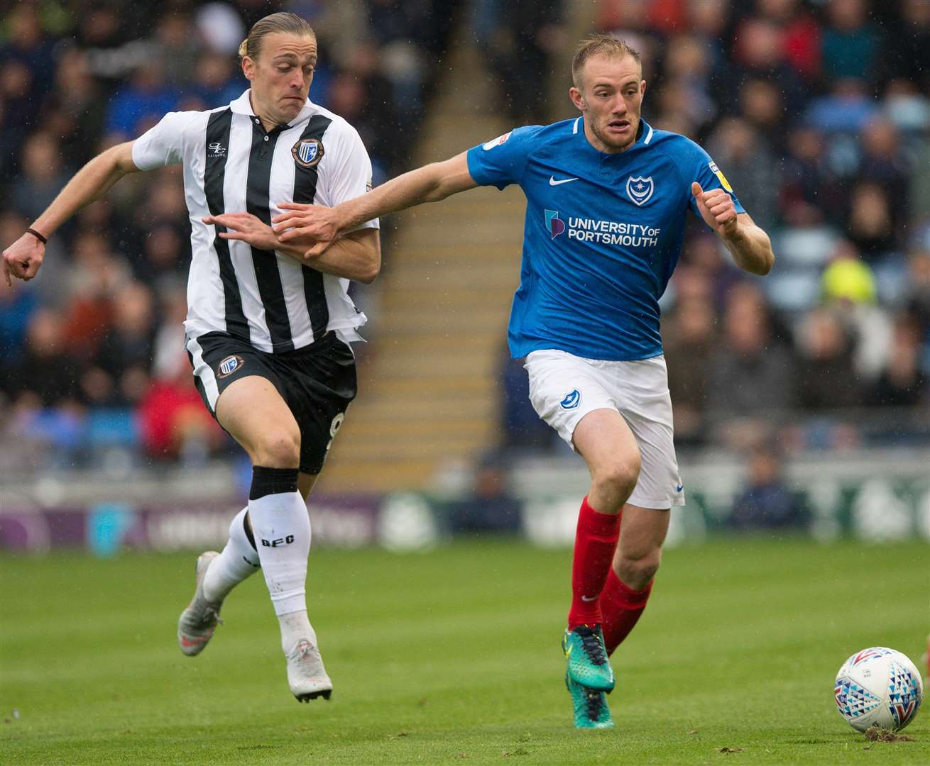 Tom Eaves chases back against Portsmouth's Matt Clarke Picture: Ady Kerry