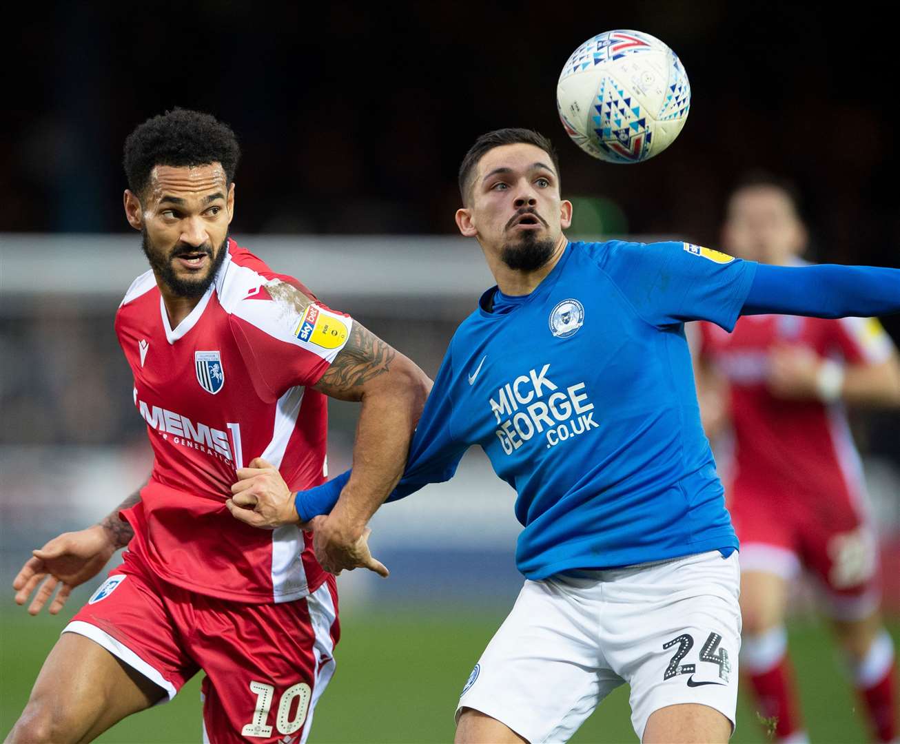 Gillingham's .Jordan Roberts challenges with Peterborough's Niall Mason Picture: Ady Kerry