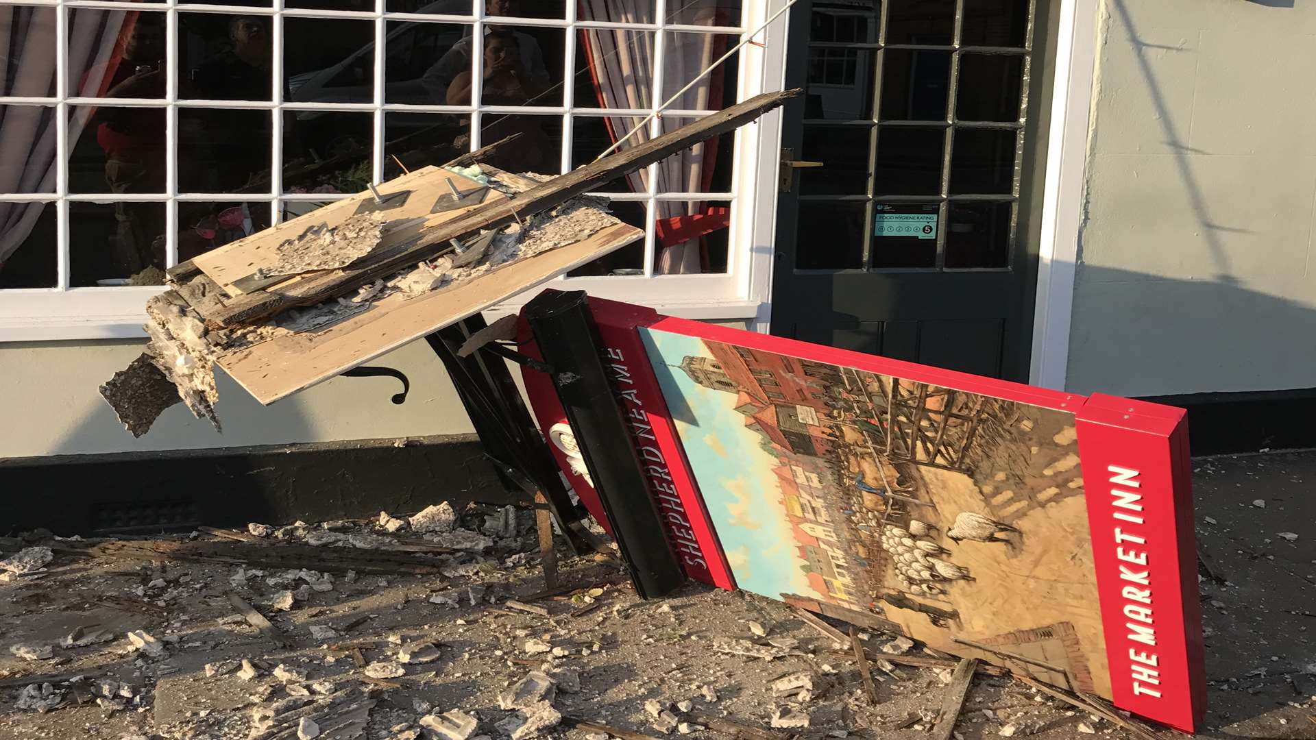 The sign lying on the pavement amongst the rubble