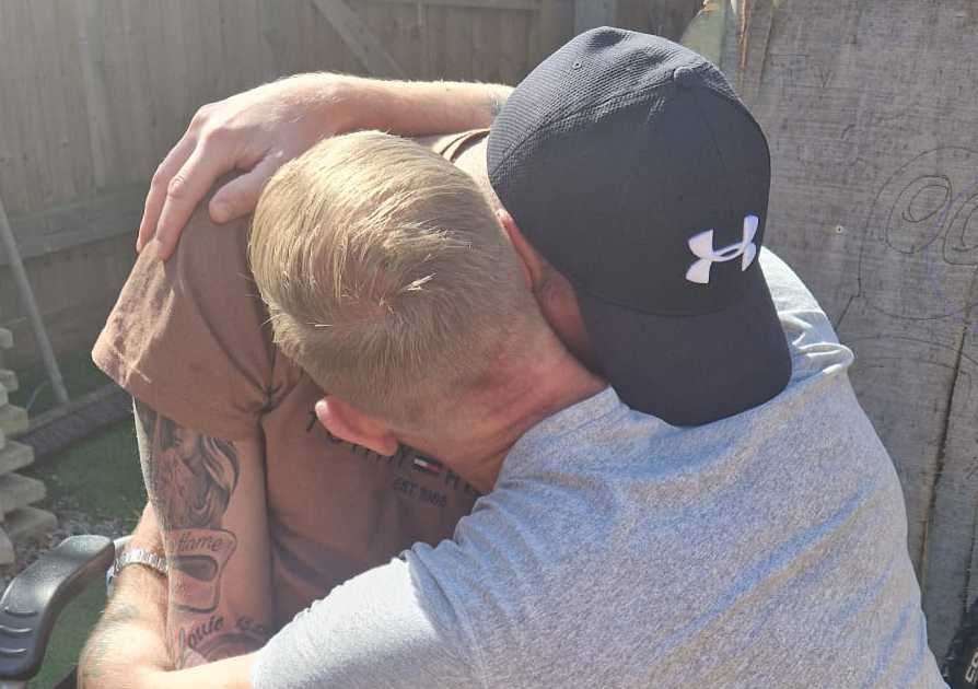 Aaron hugging Rick after coming home with the treatment. Picture: Katrina Binfield