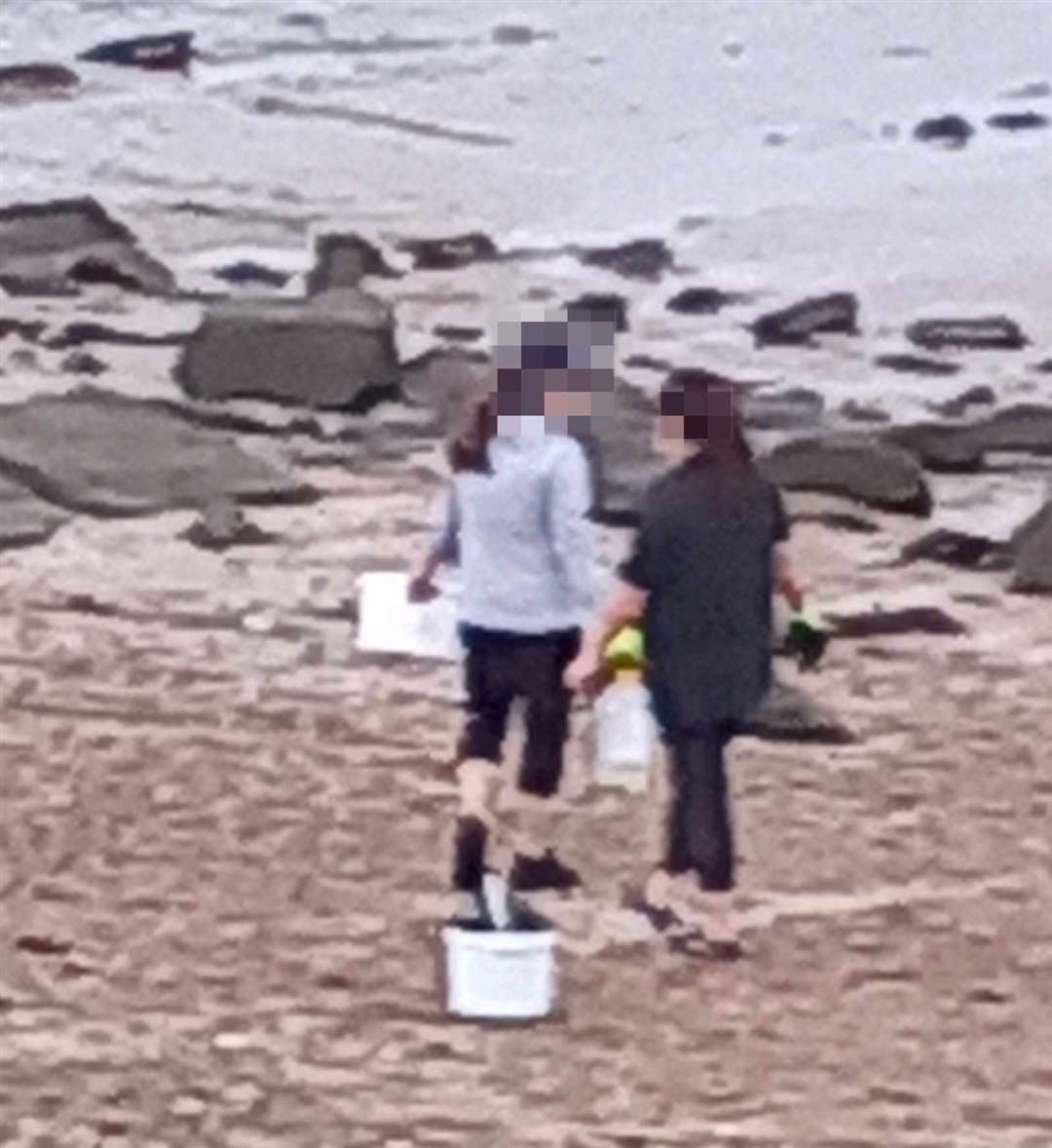 Two women with with buckets, understood to be collecting cockles at Minster Leas. Picture: Mandy Yates