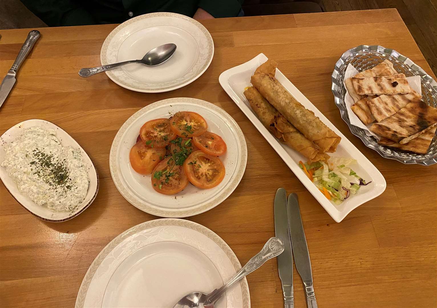 A spread of meze - sucuk, etli borek and cacik dip with flatbread