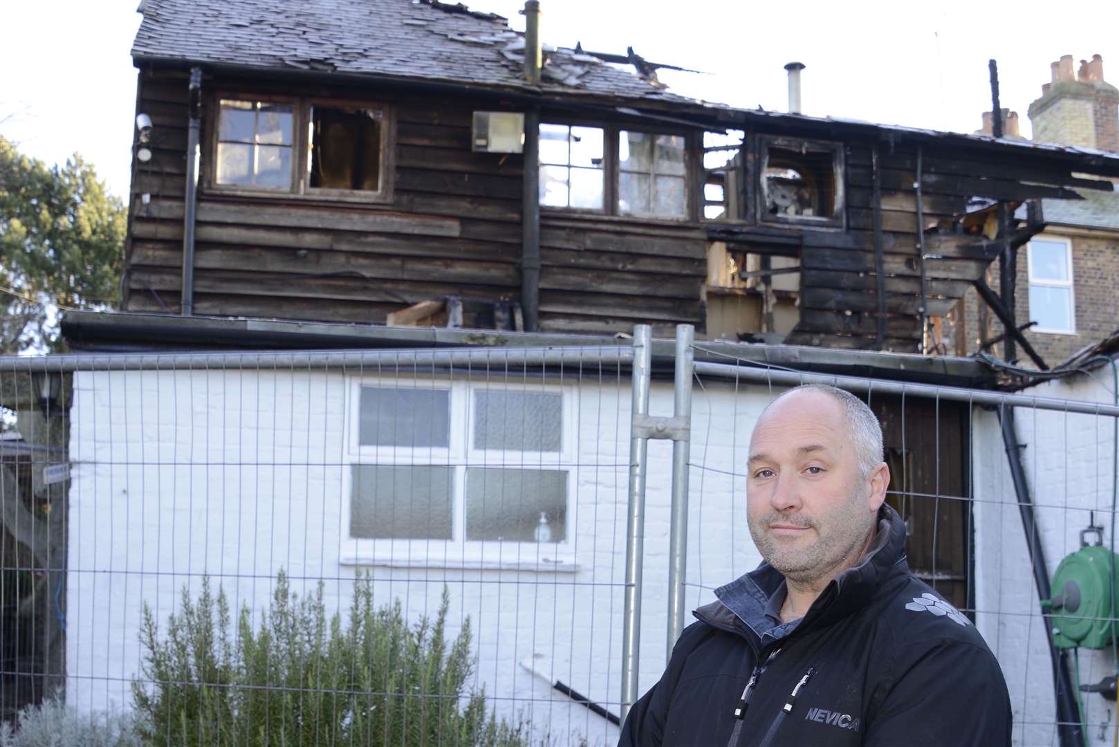 Howard Lapish with the burnt-out pub in 2016